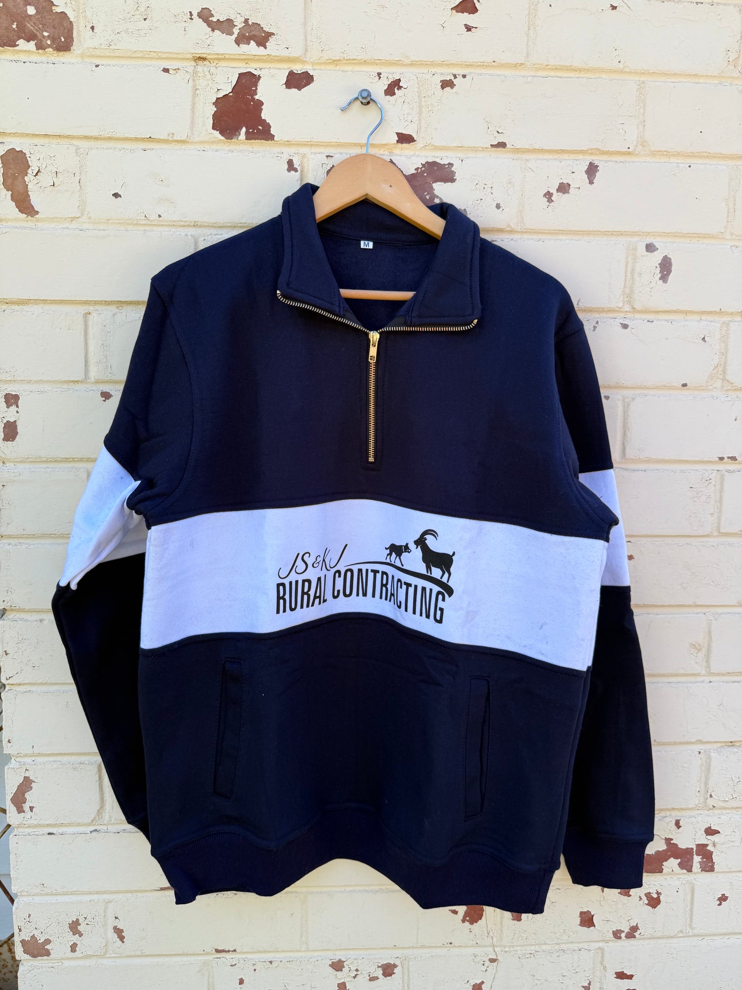 Zip up navy jumper.