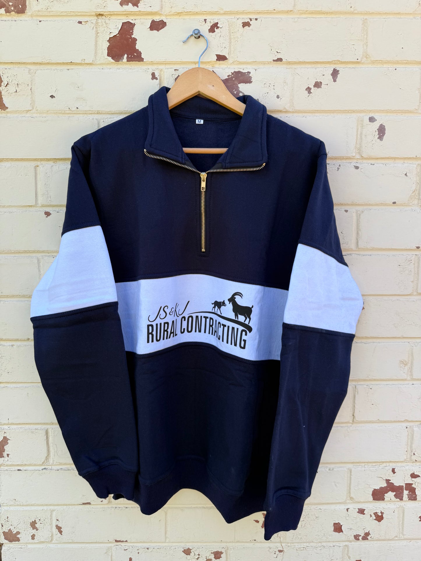 Zip up navy jumper.