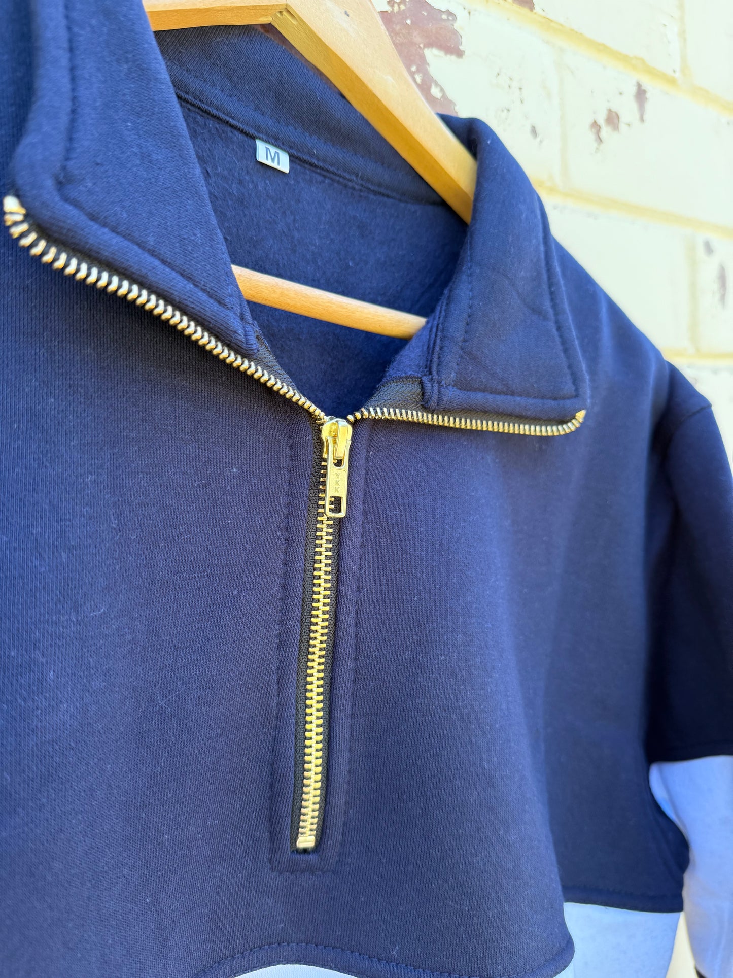Zip up navy jumper.