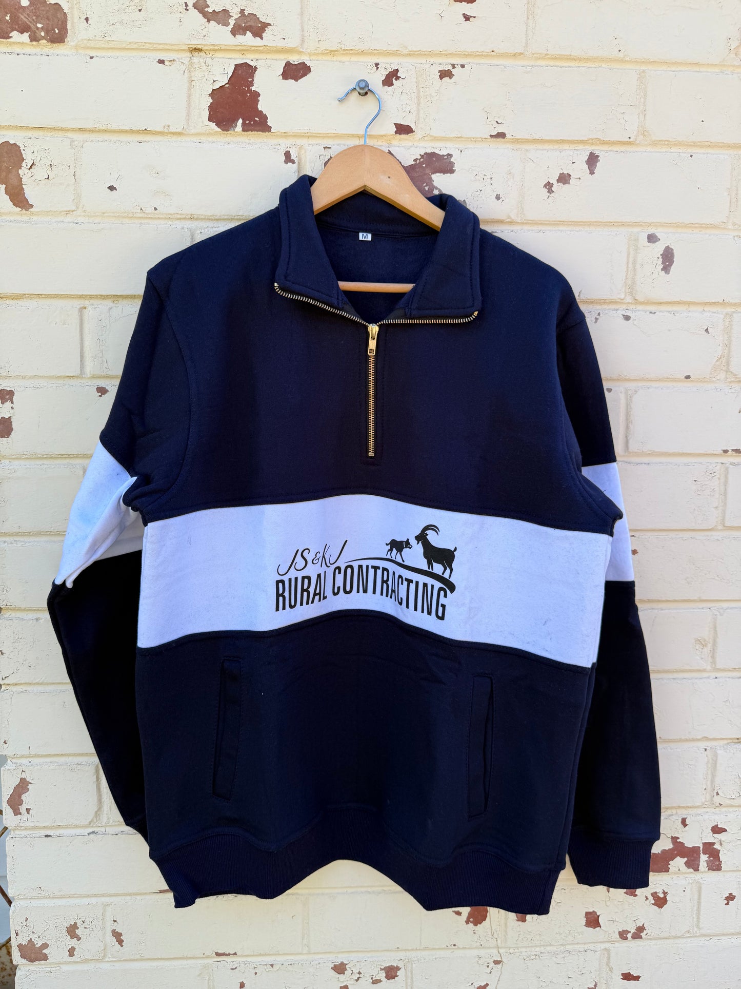 Zip up navy jumper.